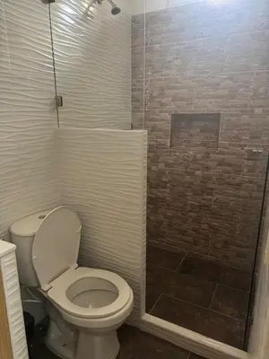 a bathroom with a toilet and a shower at Angel Mari a Doradal in Doradal
