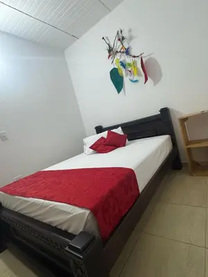 a bedroom with a bed with a red blanket at Angel Mari a Doradal in Doradal