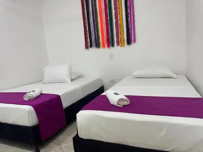 two beds sitting next to each other in a room at Angel Mari a Doradal in Doradal