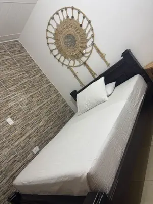 a bed in a room with a mirror on the wall at Angel Mari a Doradal in Doradal