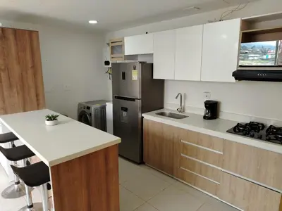 a kitchen with a stainless steel refrigerator and a counter at Frente al Malecón con Vista, Zona Gastronómica, PARQUEDERO GRATIS in Guatapé