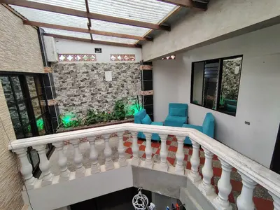 a balcony of a house with blue chairs at Casa Hévenie, Amplia, familiar, cómoda y bien ubicada in El Poblado