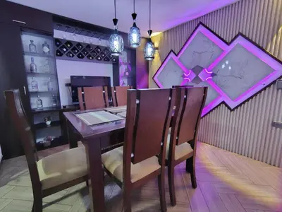 a dining room with a wooden table and chairs at Casa Hévenie, Amplia, familiar, cómoda y bien ubicada in El Poblado