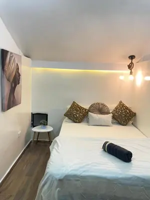 a bedroom with a bed with pillows on it at lindo apt la 70 Laurles estadio in Medellín