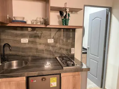 a kitchen with a stove and a sink at lindo apt la 70 Laurles estadio in Medellín