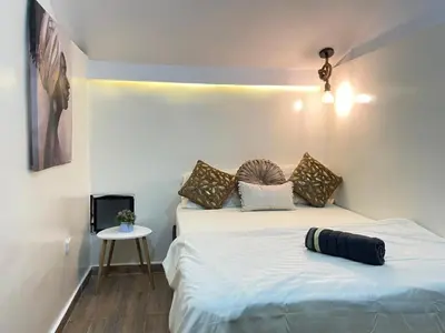 a bedroom with two beds and a small table at lindo apt la 70 Laurles estadio in Medellín