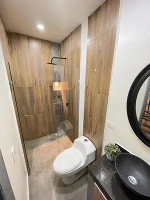 a bathroom with a toilet and a sink and a shower at lindo apt la 70 Laurles estadio in Medellín