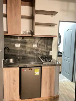 a kitchen with a stove and a sink at lindo apt la 70 Laurles estadio in Medellín