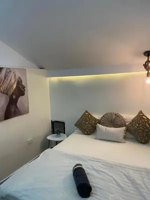 a bed with a black object laying on top of it at lindo apt la 70 Laurles estadio in Medellín
