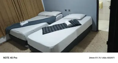 two beds sitting next to each other in a room at Medellin Continental Hotel in Medellín