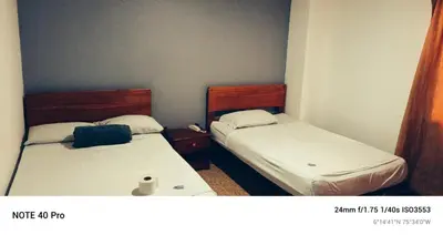 two beds in a small room with at Medellin Continental Hotel in Medellín