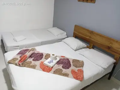 two beds in a room with towels on them at Medellin Continental Hotel in Medellín