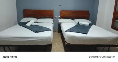 three beds in a room with towels on them at Medellin Continental Hotel in Medellín
