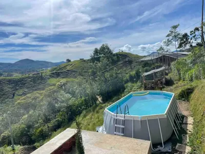 a hot tub on a hill next to a house at 180 degree Mountain View with good size pool in Piedra El Marcial