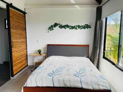 a bedroom with a bed and a window at 180 degree Mountain View with good size pool in Piedra El Marcial
