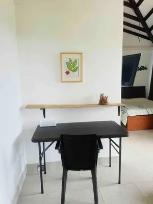a desk with a chair in a room with a bed at 180 degree Mountain View with good size pool in Piedra El Marcial