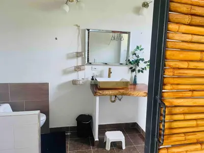 a bathroom with a sink and a mirror at 180 degree Mountain View with good size pool in Piedra El Marcial