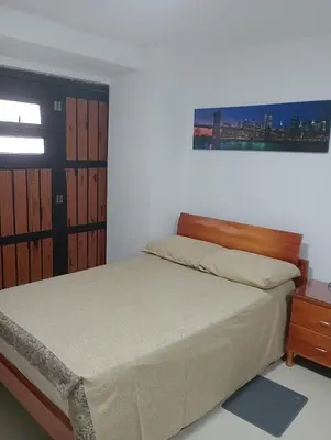a bedroom with a bed with a wooden headboard at 