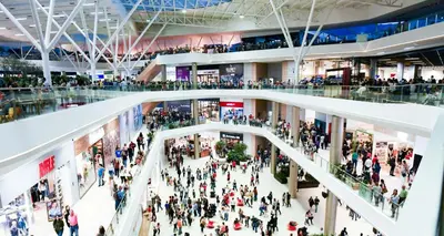 a large crowd of people in a shopping mall at 