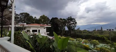 a house with a view of a garden at Romeral Club Campestre in La Estrella