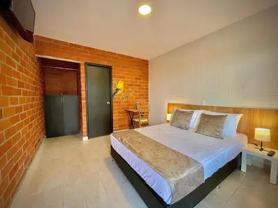 a bedroom with a bed and a brick wall at Romeral Club Campestre in La Estrella