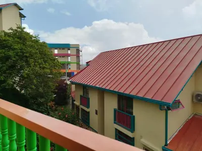 a building with a red roof on a balcony at casa Guatape cerca al parque y malecom in Guatapé