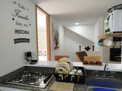 a kitchen with a stove and a counter top at casa Guatape cerca al parque y malecom in Guatapé