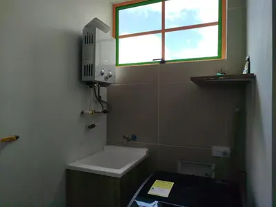 a small bathroom with a sink and a window at casa Guatape cerca al parque y malecom in Guatapé