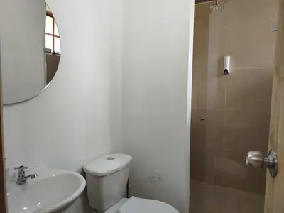 a bathroom with a toilet and a sink and a mirror at casa Guatape cerca al parque y malecom in Guatapé