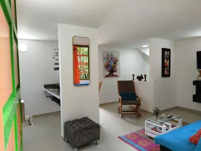 a living room with a blue couch and a chair at casa Guatape cerca al parque y malecom in Guatapé