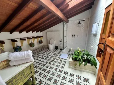 a bathroom with a tub and a toilet in a room at Hotel Boutique Sagrado Corazon in Abejorral