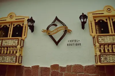 a clock on the side of a wall with lights at Hotel Boutique Sagrado Corazon in Abejorral