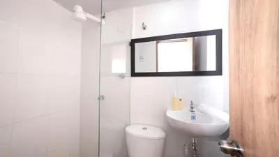 a bathroom with a toilet and a sink and a shower at Boston Coffee Lofts in Medellín