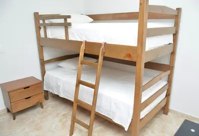 a room with two bunk beds and a table at Hummingbird in Chinchiná