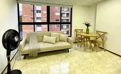 a living room with a couch and a table at 41 Experience Laureles in style and comfort in Medellín