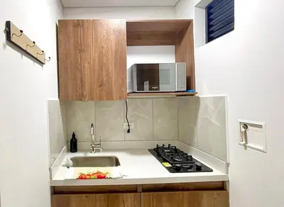 a kitchen with a sink and a microwave at 41 Experience Laureles in style and comfort in Medellín