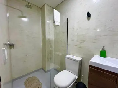 a bathroom with a toilet and a sink and a shower at 41 Experience Laureles in style and comfort in Medellín
