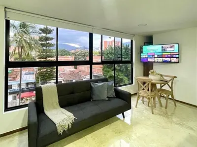 a living room with a couch and a table at 42 Modern Loft Top Location Laureles Medellín in Medellín