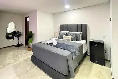 a bedroom with a large bed in a room at 42 Modern Loft Top Location Laureles Medellín in Medellín