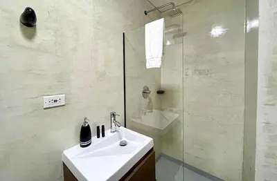 a white bathroom with a sink and a shower at 42 Modern Loft Top Location Laureles Medellín in Medellín