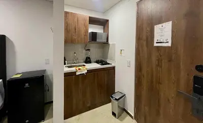 a small kitchen with a sink and a refrigerator at 42 Modern Loft Top Location Laureles Medellín in Medellín