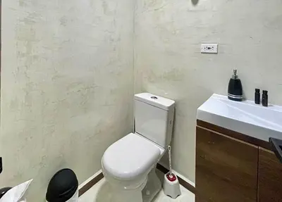 a bathroom with a white toilet and a sink at 42 Modern Loft Top Location Laureles Medellín in Medellín