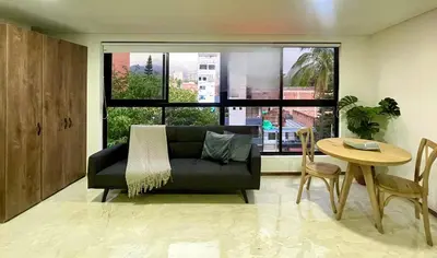a living room with a couch and a table at 44 Laureles I Medellín - Modern Loft - Céntrico y excelente ubicación in Medellín
