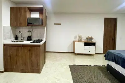a small kitchen with a sink and a microwave at 44 Laureles I Medellín - Modern Loft - Céntrico y excelente ubicación in Medellín