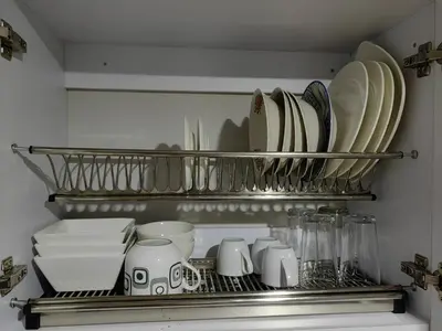 a kitchen shelf with plates and dishes on it at Edifio Barlovento in Bello