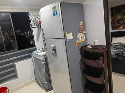 a silver refrigerator in a kitchen with a window at Edifio Barlovento in Bello