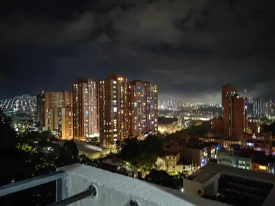 a view of a city at night with lights at Edifio Barlovento in Bello