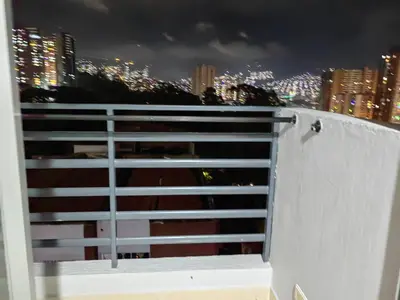 a gate with a view of a city at night at Edifio Barlovento in Bello