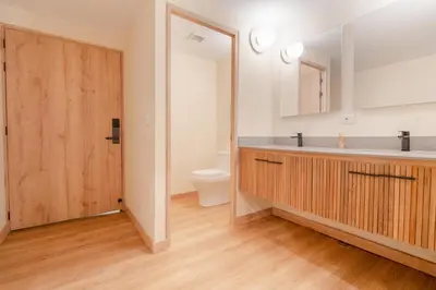 a bathroom with a sink and a toilet and a mirror at Candelaria Aparta Hotel Boutique in Medellín