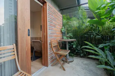a small patio with a table and a chair at Candelaria Aparta Hotel Boutique in Medellín